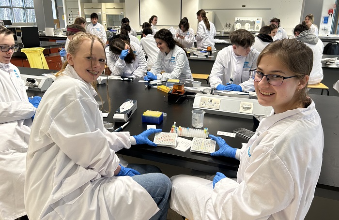 a photo of two students sitting at a lab bench
